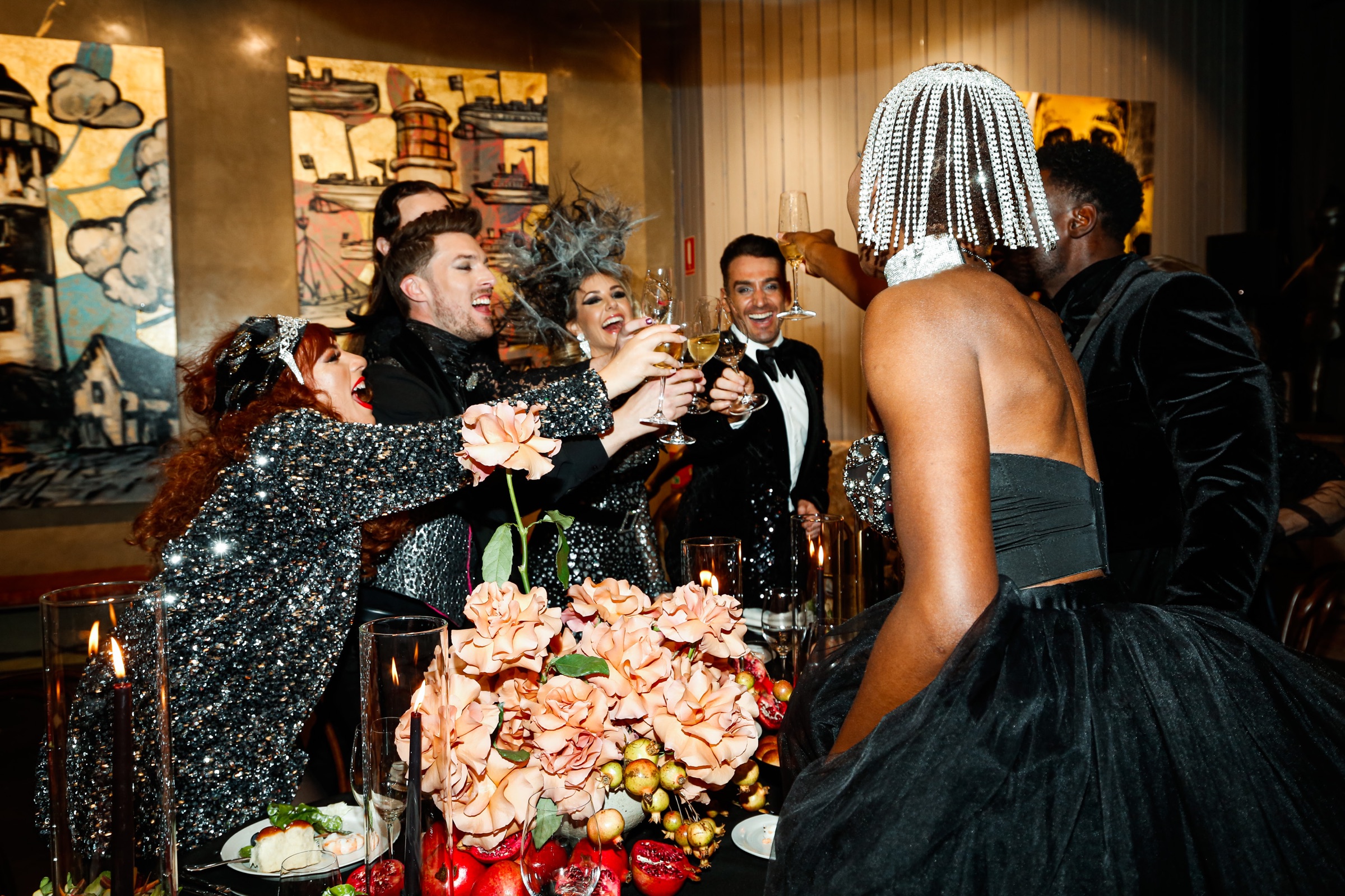 Guests raising glasses at an end-of-year celebration