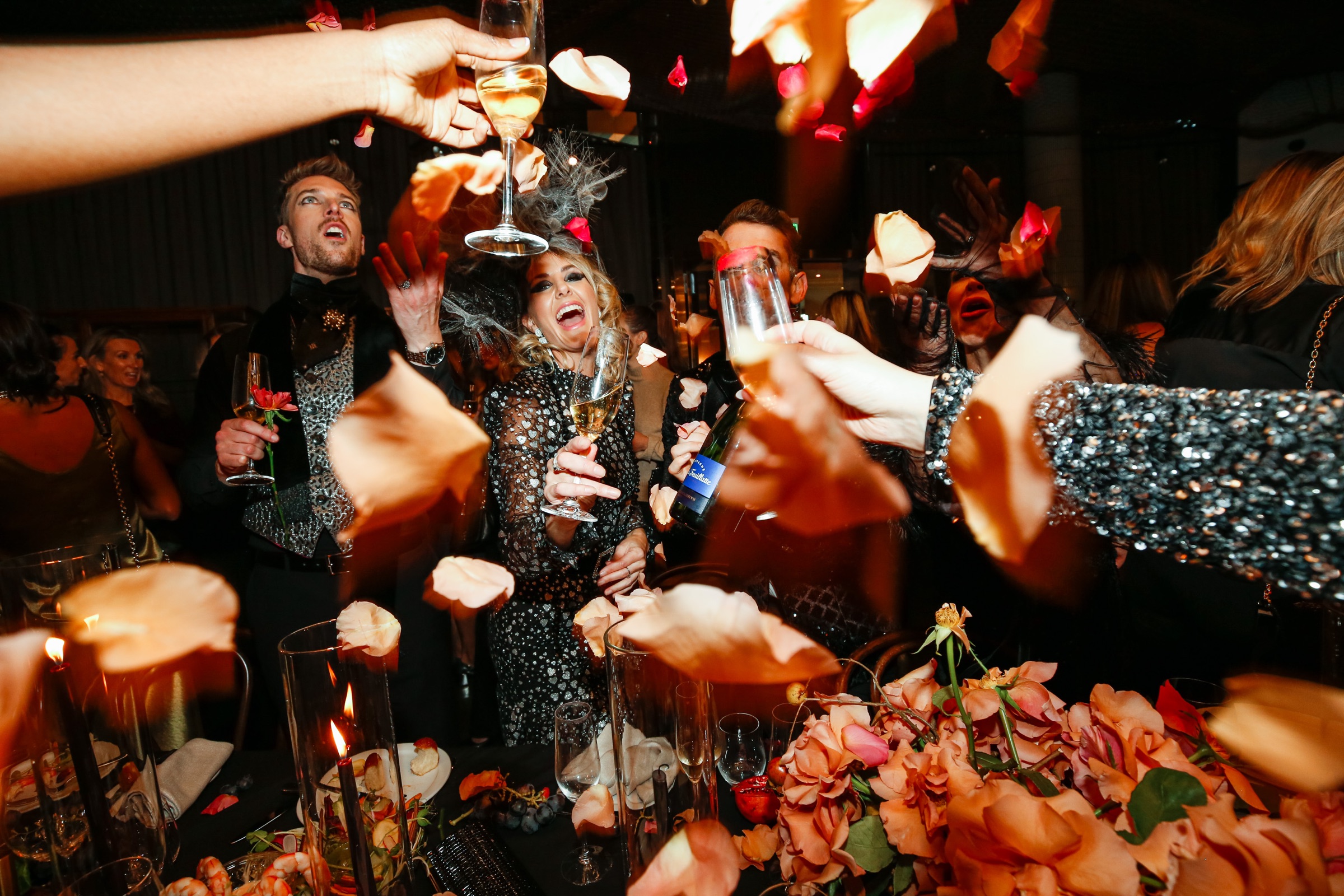 Guests celebrating with champagne and rose petals